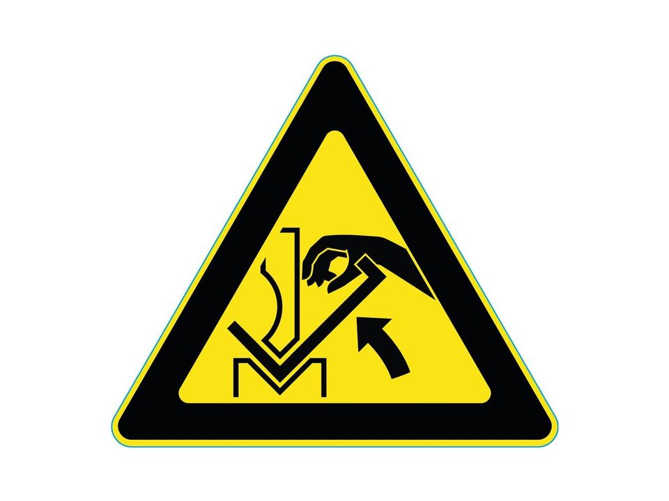 Waarschuwingssticker hand tussen werkstuk